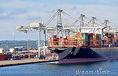 Large container ship has docked in the port o and is loading and unloading Stock Photo