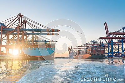 Large container ships in harbor with beautiful sunset Stock Photo