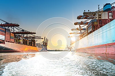 Large container ships in harbor at sunset Stock Photo