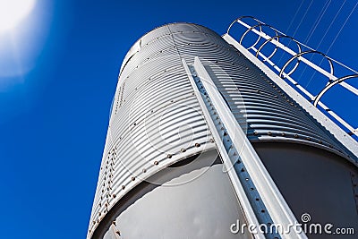 Large corrugated aluminum metal cereal silo to store feed Stock Photo