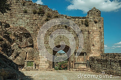 Large courtyard and open gateway on stone wall Stock Photo