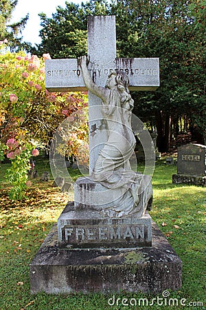 Large cross with grieving woman, Greenridge Cemetery, Saratoga Springs, New York, 2020 Editorial Stock Photo