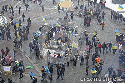 Large crowd of people protesting, tent town on Majdan Nezalezhnosti square, heavy wet snow falling. Revolution of Editorial Stock Photo