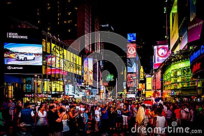 Large crowd of people in Times Square at night, in Midtown Manhattan, New York. Editorial Stock Photo