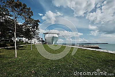 large cruise ship docked along the waterfront of Singapore Stock Photo