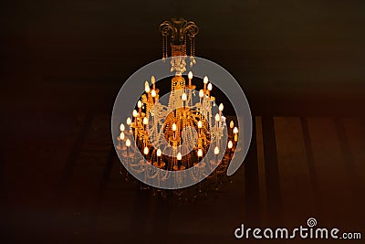 Large crystal chandelier with yellow light Stock Photo