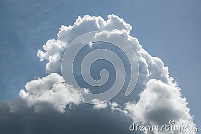 A large cumulus cloud in a blue sky with cirrus clouds. Stock Photo