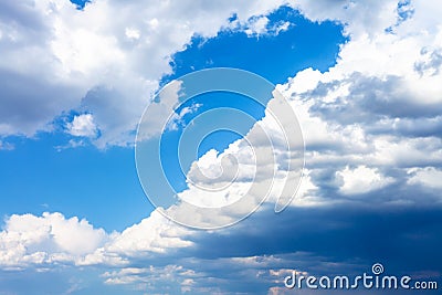 large dark rainy clouds in blue sky in spring Stock Photo