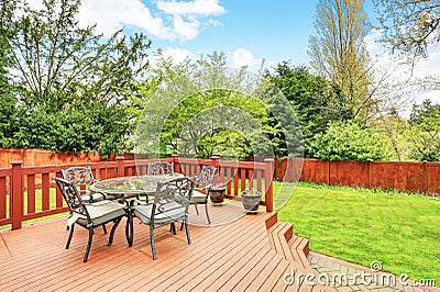 Large deck with dining space overlooking spacious back yard. Stock Photo