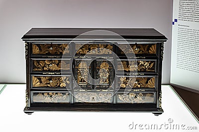 The large decorative carved wooden chest of drawers - exhibit at the museum of the Sforzesco Castle - Castello Sforzesco in Milan Editorial Stock Photo