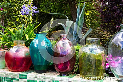 Colorfull, decorative glass jars in the garden Stock Photo