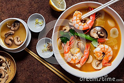 Large deep plate with tom yam soup with mushroom pieces and boiled shrimp Stock Photo