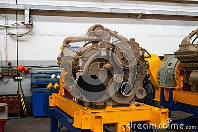 Large diesel engine with a huge turbine in the warehouse of finished products factory for the production of large mining trucks Stock Photo