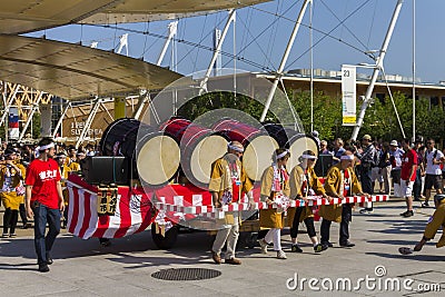 Large drums on a cartwheel on the Japanese traditional parade on EXPO 2015 Editorial Stock Photo