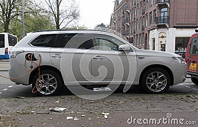 large electric car at a charging point in the streets of Amsterdam Editorial Stock Photo