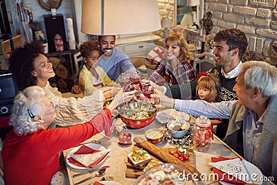 Large family clinking glasses on Christmas dinner Stock Photo