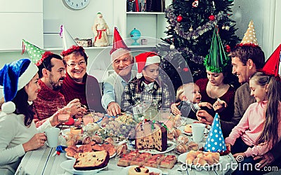 Large family eating together during festive Christmas dinner Stock Photo