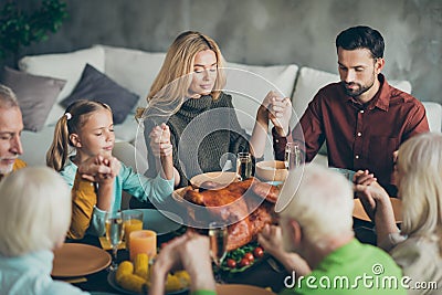 Large family gathering on thanksgiving day sit table enjoy october meal hold hands pray meeting mature relatives small Stock Photo