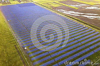 Large field of solar photo voltaic panels system producing renewable clean energy on green grass background Stock Photo