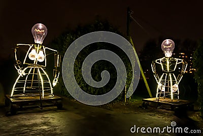 Large figures of burning light bulbs of a woman and a man Editorial Stock Photo
