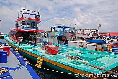 A row of modern large fishing vessel boat boats with deck docking nearby the fish market at Male Maldives Editorial Stock Photo