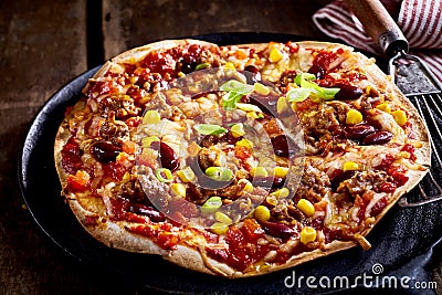 Large flat bread tortilla pizza in pan Stock Photo