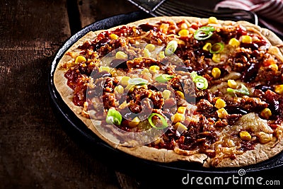 Large flat tortilla pizza in pan cropped on side Stock Photo