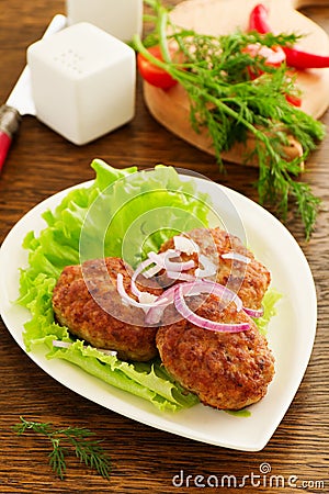 Large fried cutlets with lettuce. Stock Photo