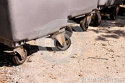 Large garbage containers, trash dumpsters and bins standing in row. Orderly stowed garbage cans. Stock Photo