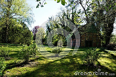 Large garden with half-timbered brick house in a park Stock Photo