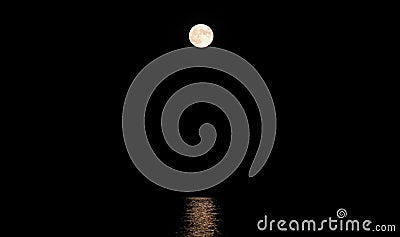 giant moon very bright and reflected to be on the placid water o Stock Photo