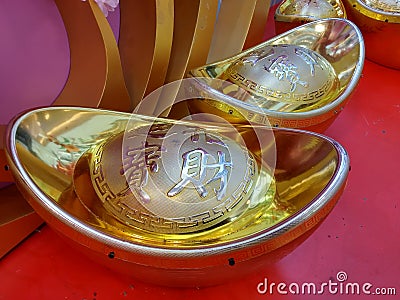 Large gold ingot as a festive decoration for the Spring Festival Editorial Stock Photo