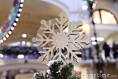 Large golden snowflake on top of a Christmas tree Stock Photo