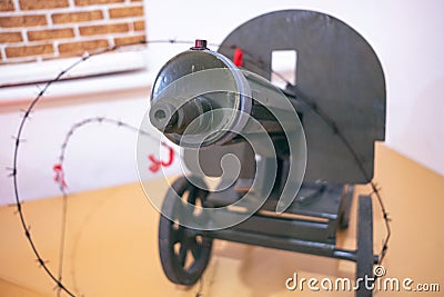 A large green machine gun on a pedestal with a muzzle aimed at us Editorial Stock Photo