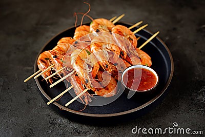 Large grilled prawns on wooden skewers. Shrimp kebabs. Stock Photo