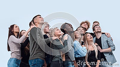 Large group of diverse young people looking up hopefully Stock Photo