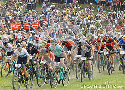 Large group of fighting mountainbike cyclists cycling uphill Editorial Stock Photo