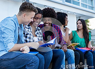 Large group of international students learning outdoors on campus Stock Photo