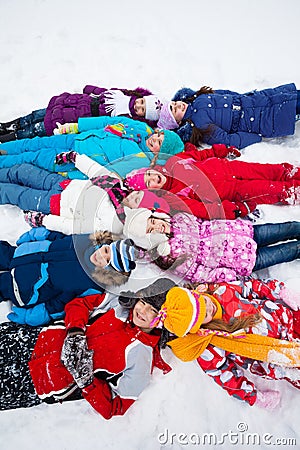 Large group of kids laying in snow Stock Photo