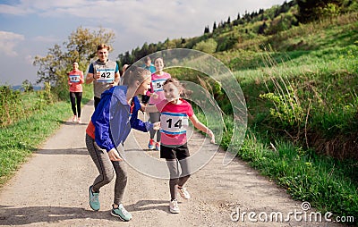 Large group of multi generation people running a race competition in nature. Stock Photo