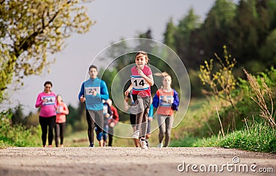 Large group of multi generation people running a race competition in nature. Stock Photo