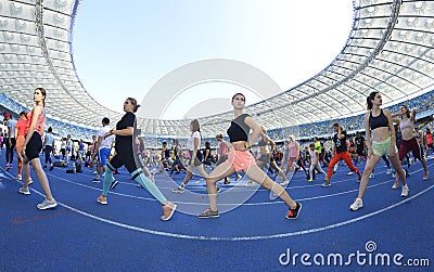 Large group of people doing morning exercises on the stadium Editorial Stock Photo