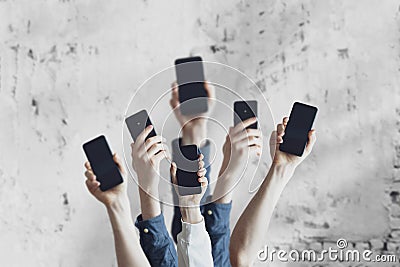 a large group of people hold digital phones device, many human hands Stock Photo