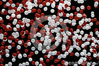 Large group of red and white balloons being released in the night sky Stock Photo