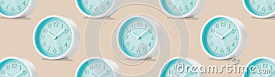 Large group of round analog table clocks with on a beige plain background. Low angle view. Web banner Stock Photo