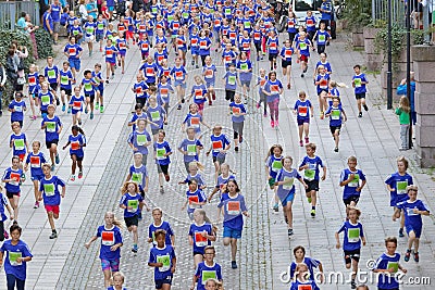 Large group of running girls and boys in blue Editorial Stock Photo