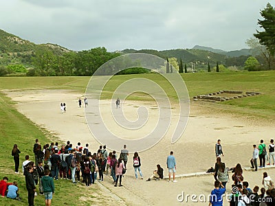 Large group of students enjoy visiting the old stadium of Ancient Olympia, UNESCO world heritage site in Greece Editorial Stock Photo