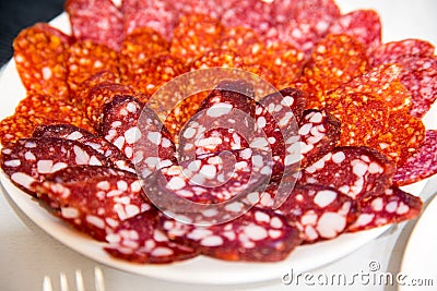 Large group of thinly sliced sausages on a plate Stock Photo