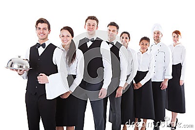 Large group of waiters and waitresses standing in row Stock Photo