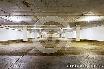 Large grungy empty undercover parking area Stock Photo